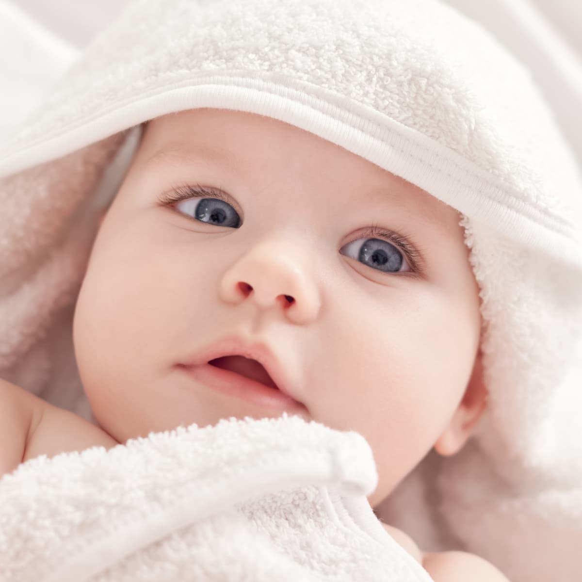 Close-up of baby wrapped in towel.