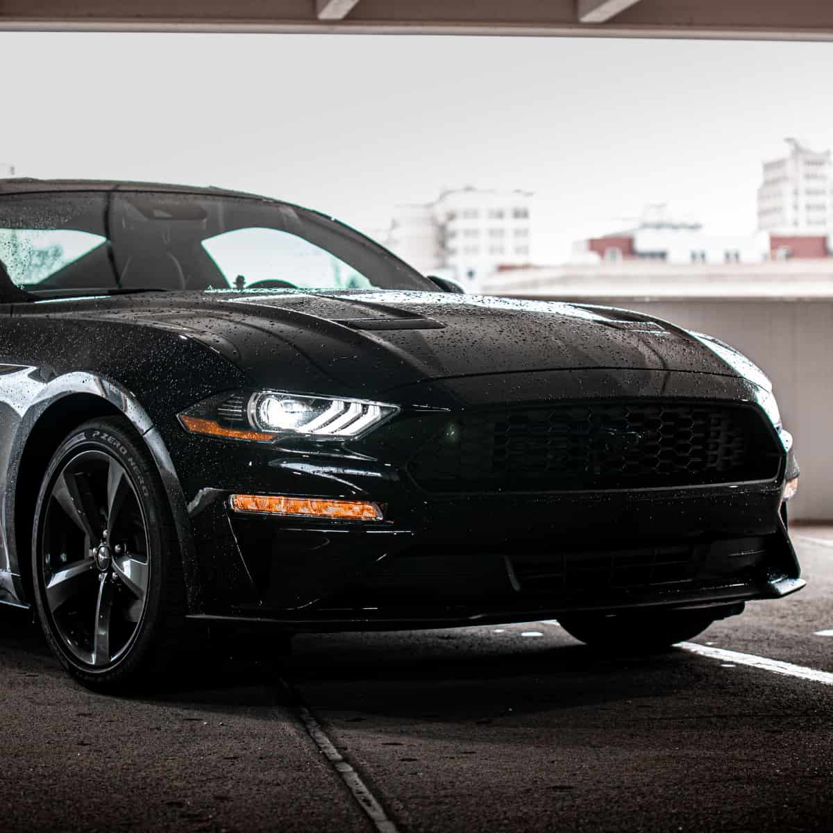 Front of Mustang parked in garage.