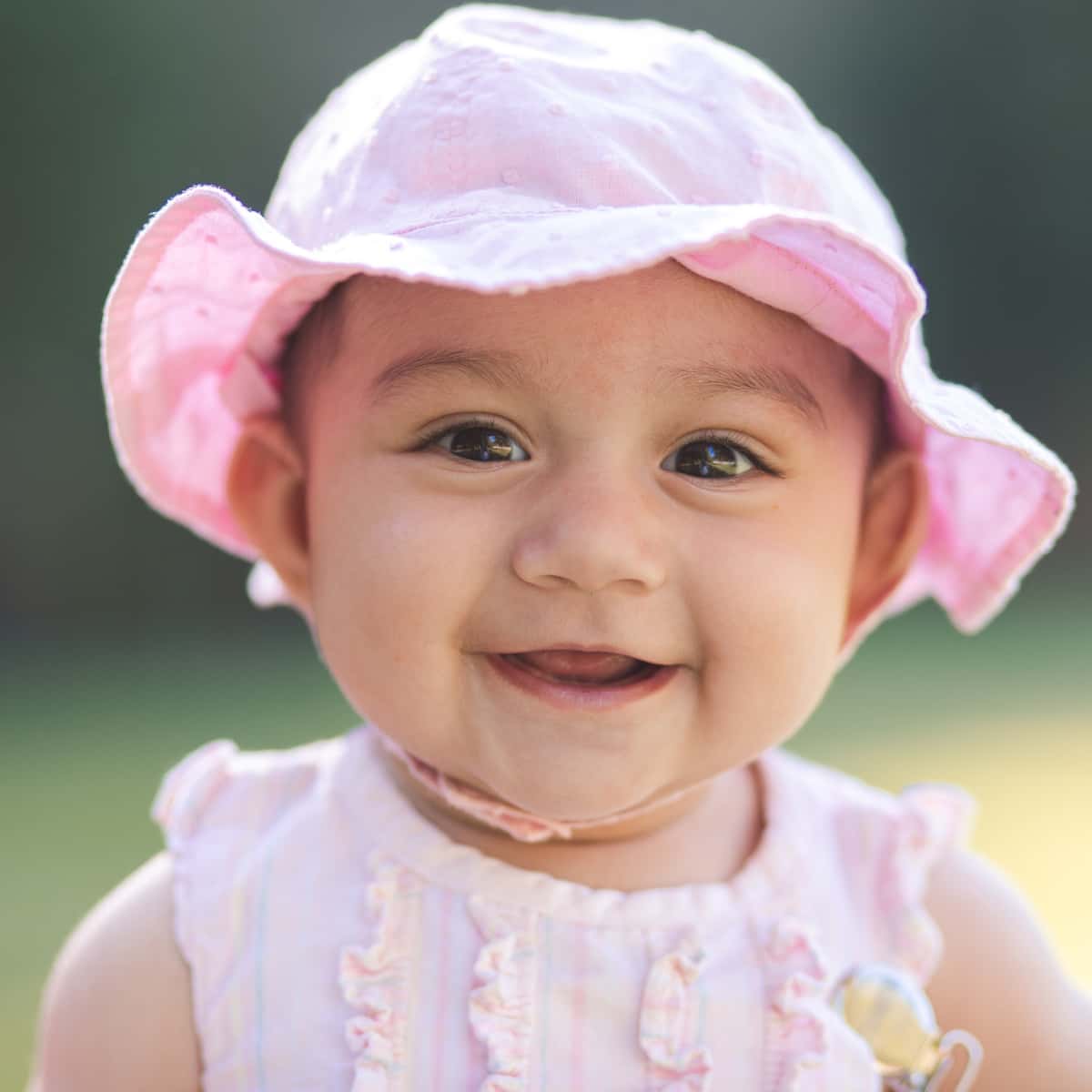 Close-up of baby girl wearing hat.