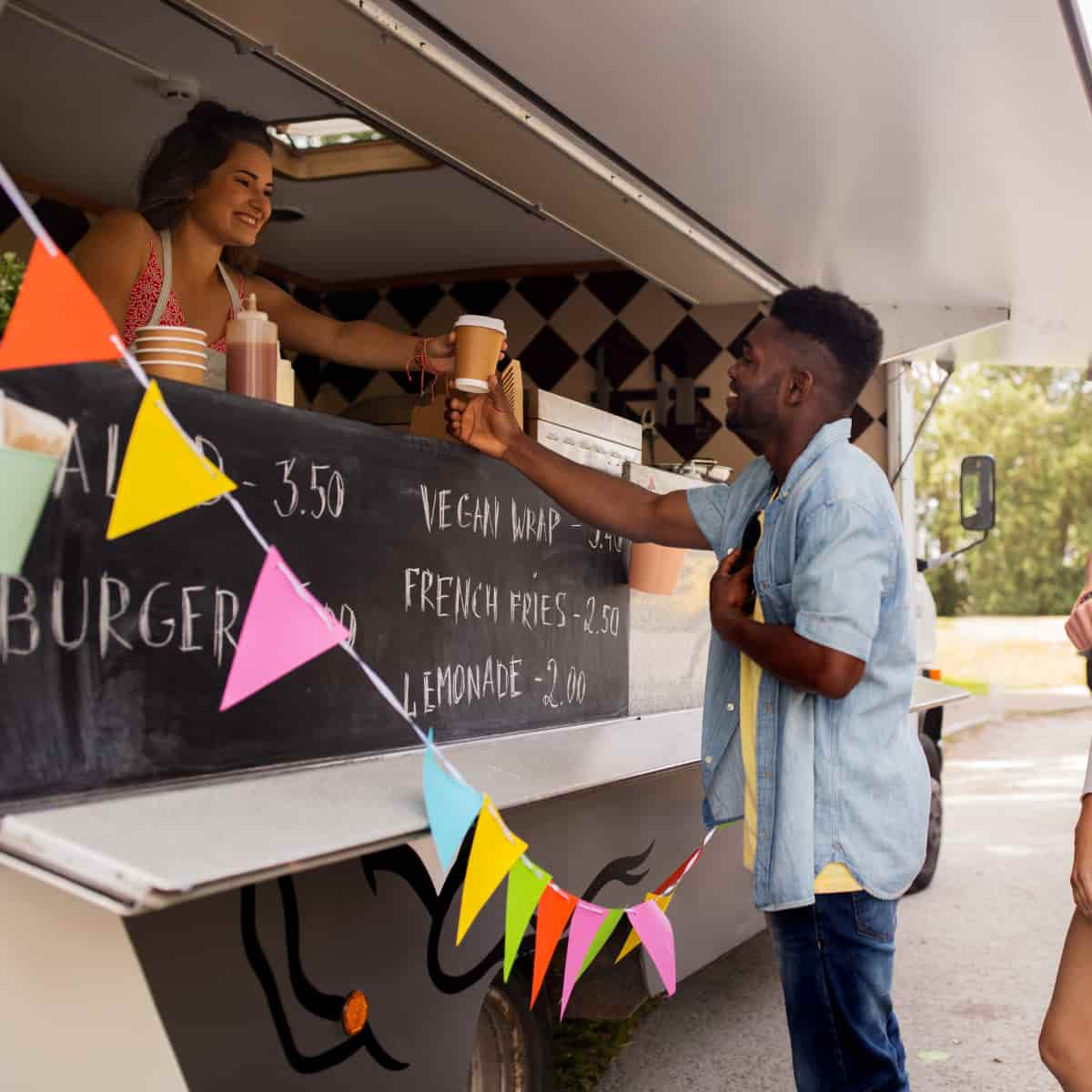 Man getting coffee from food truck.