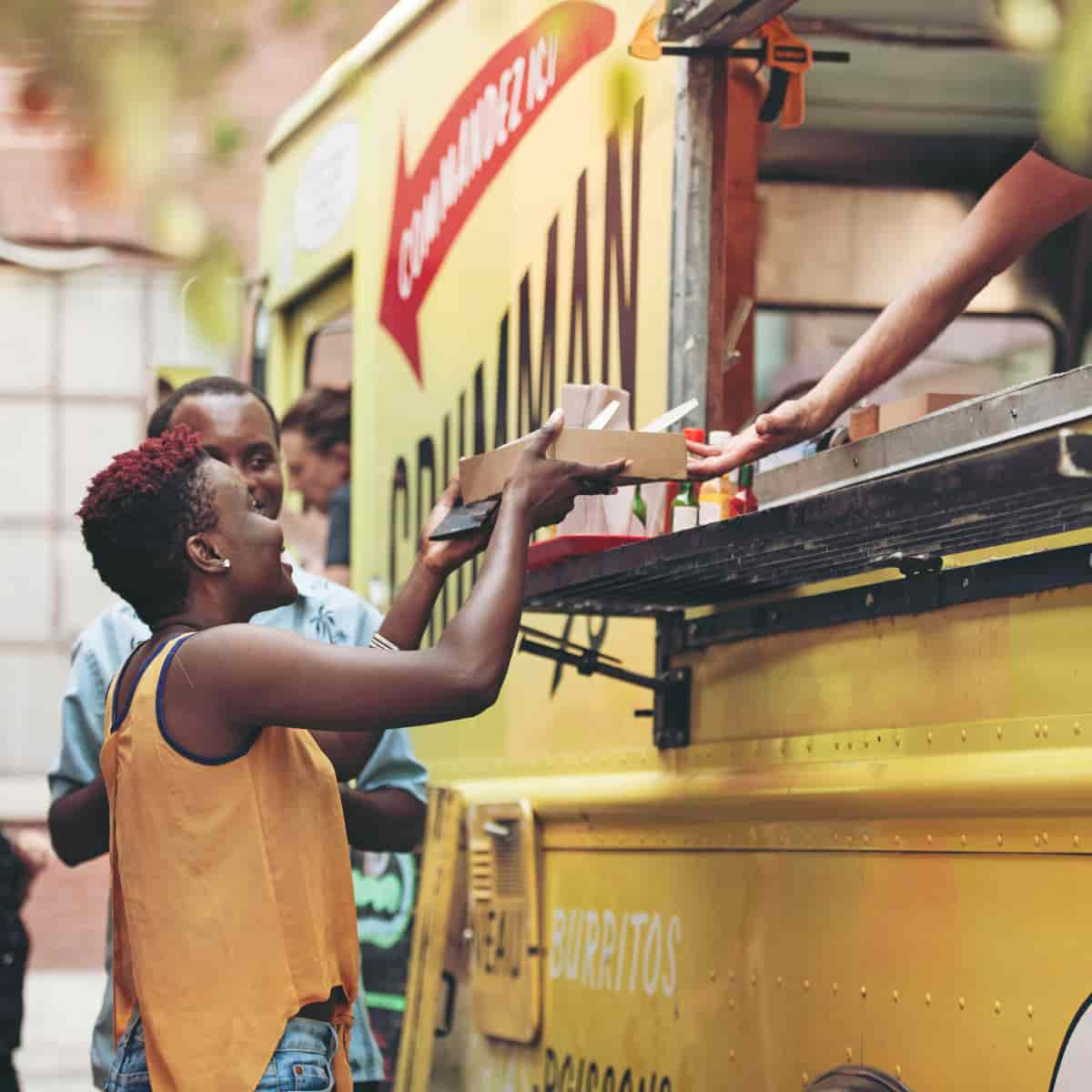 Woman buying food from food truck.