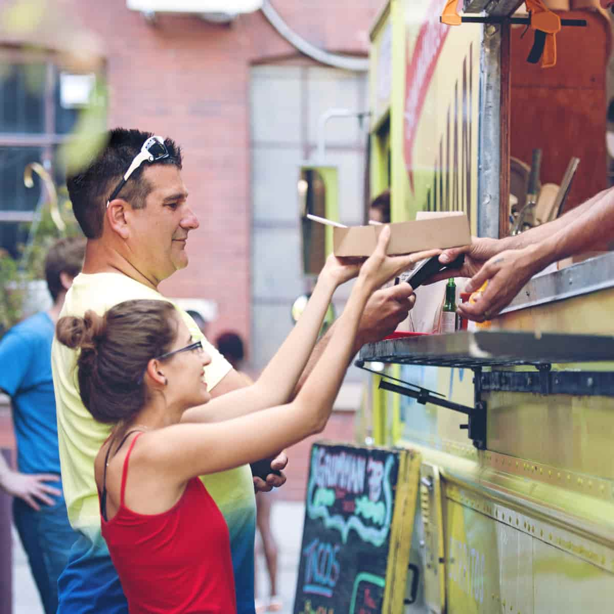 People getting food from food truck.