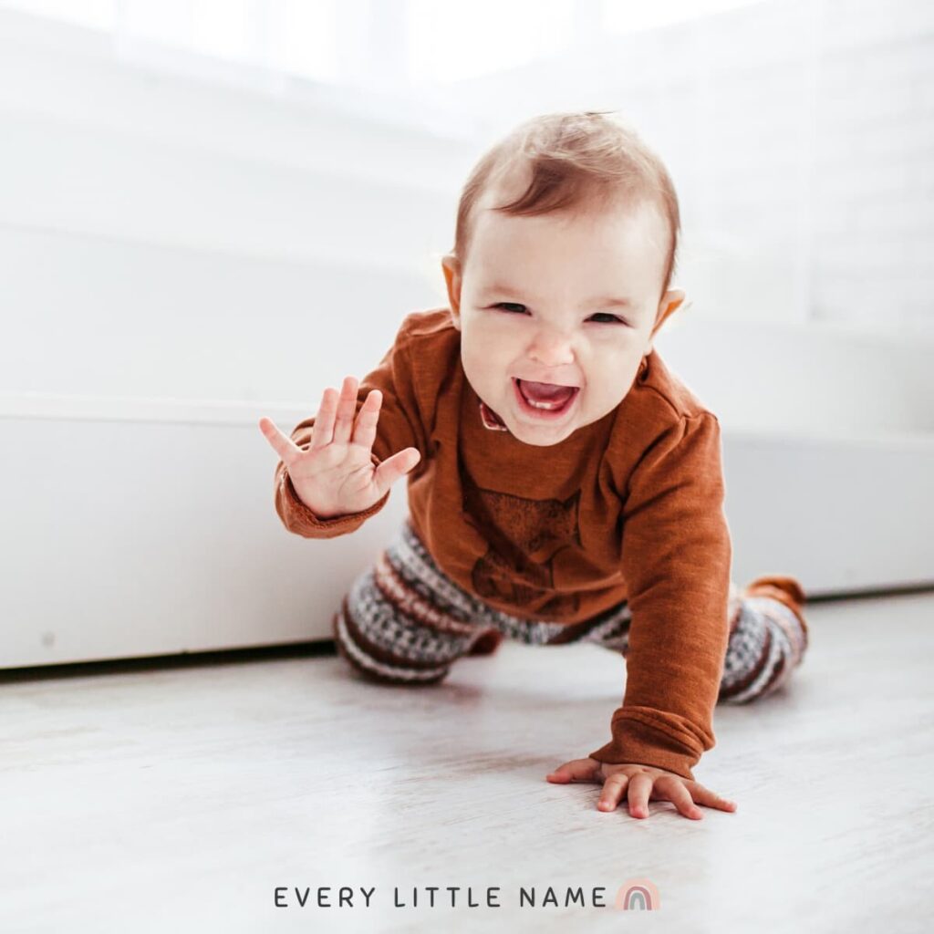 Baby laughing and crawling on floor.