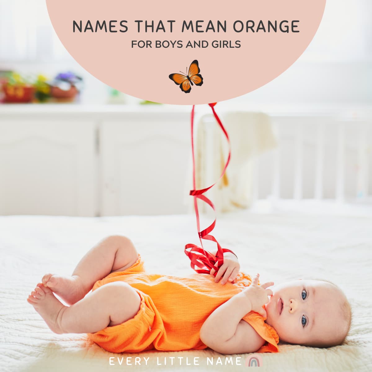 Baby wearing an orange romper and holding an orange balloon.