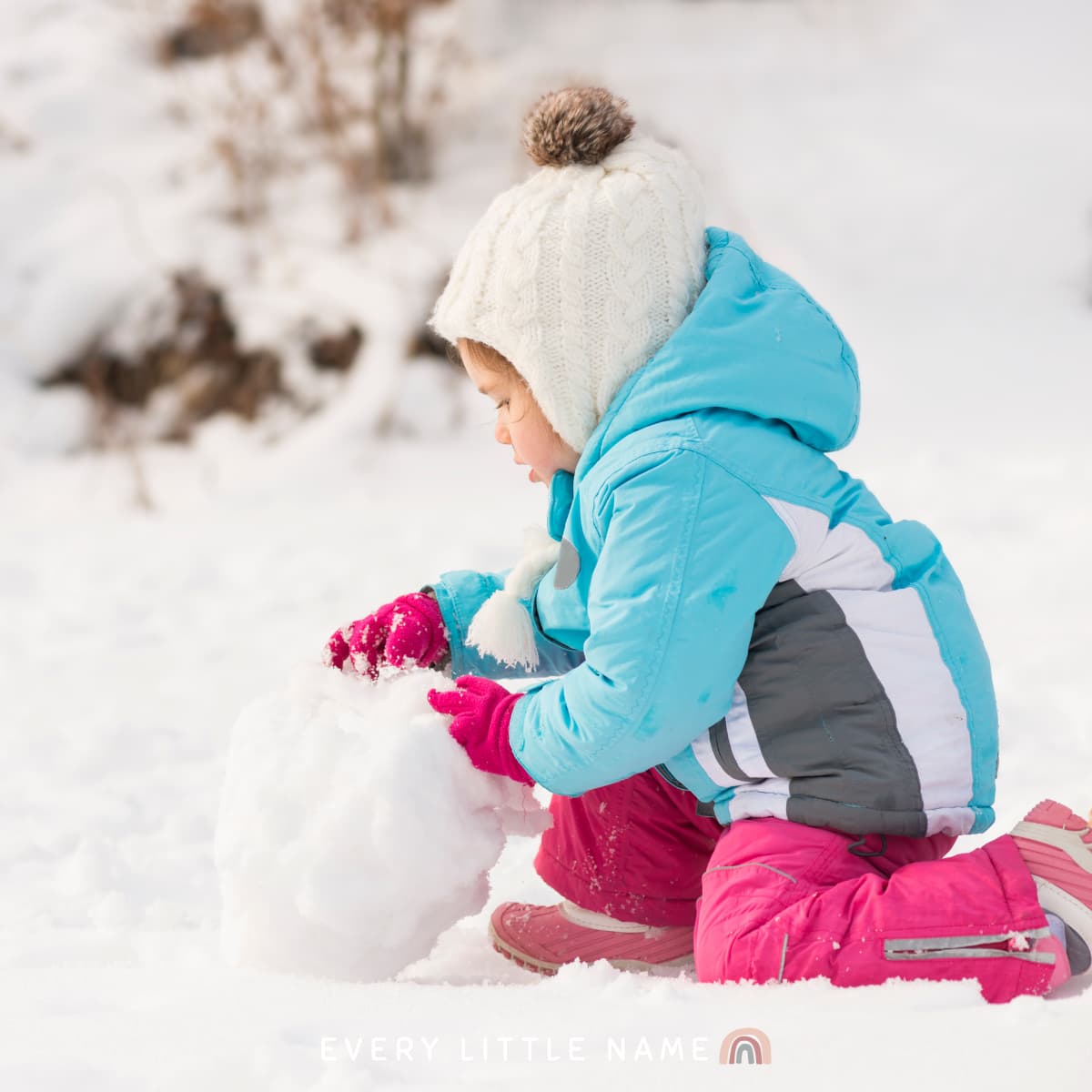 Child building snowman.