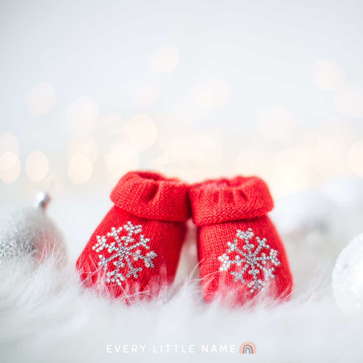 Set of red baby booties with snowflakes.